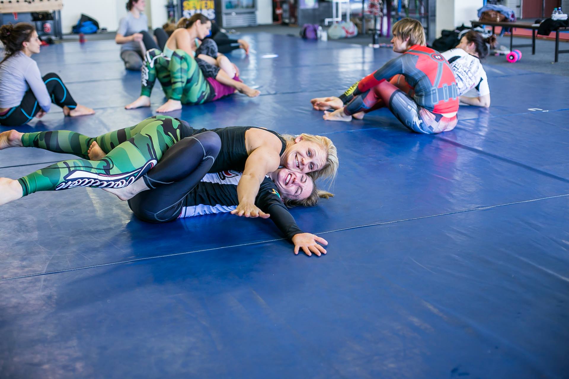 South African women rolling no-gi with big smiles on the mats